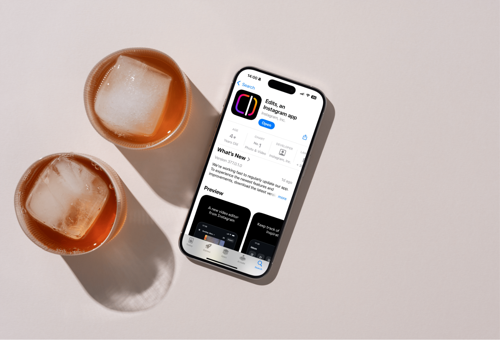 “iPhone screen showing the Instagram Edits app download page on the App Store, next to two iced drinks on a neutral background — illustrating how to use Instagram Edits to create and edit Reels.”