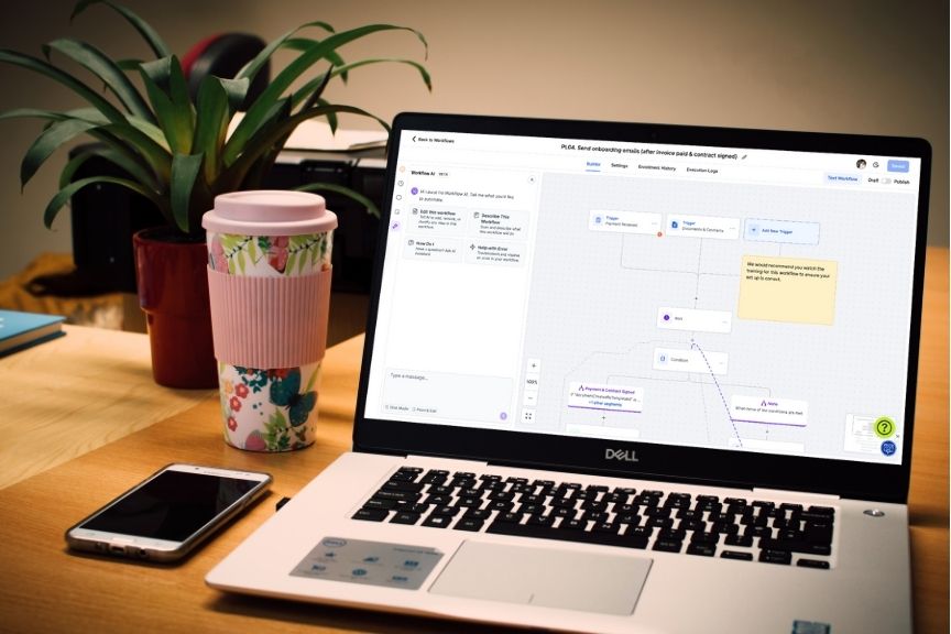 Laptop on a desk shows a hubsy workflow to onboard a new client